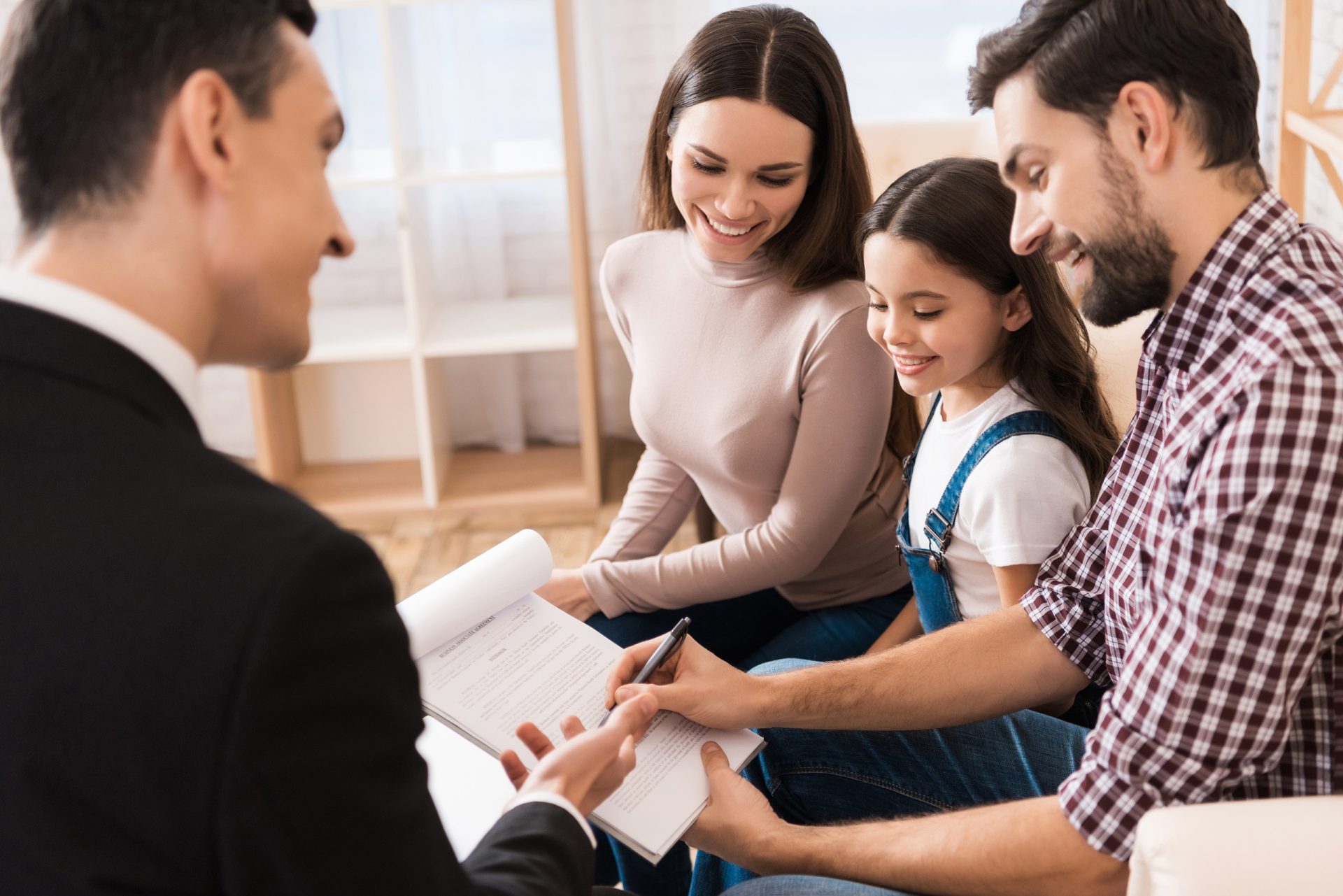 Young family signs associate agreement to buy house